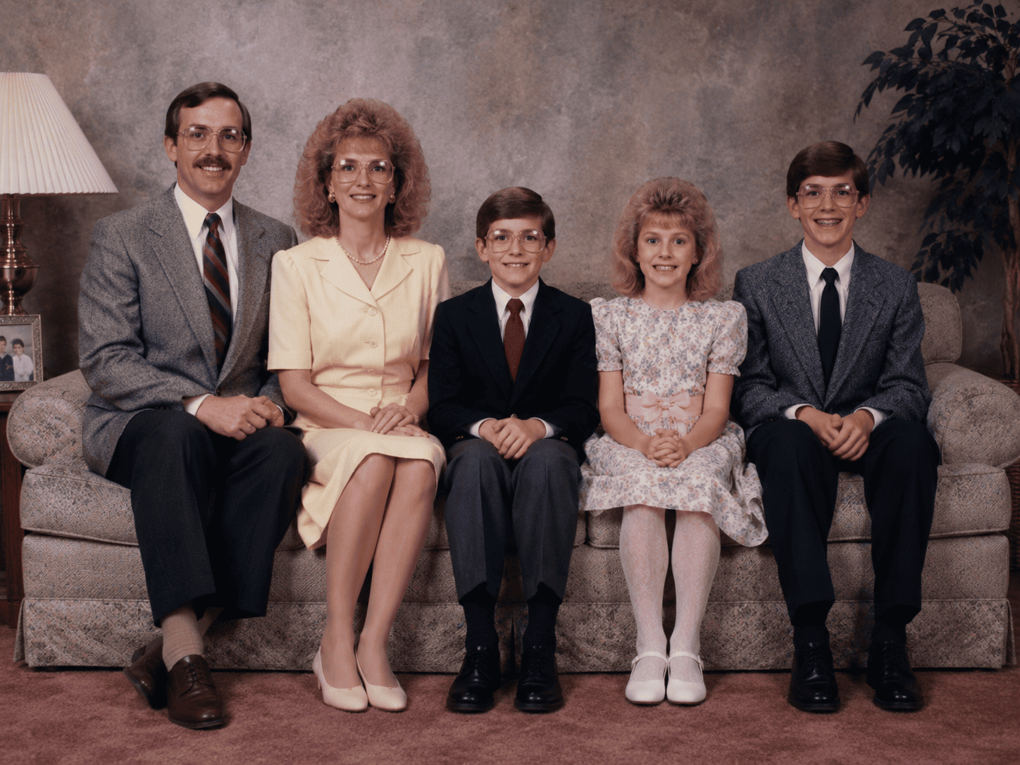 Awkward family photo pose idea with a hands on shoulders pyramid